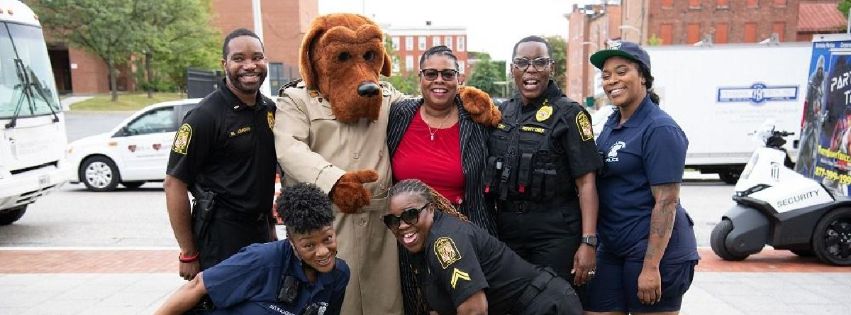 Officers pose with McGruff the Crime Dog