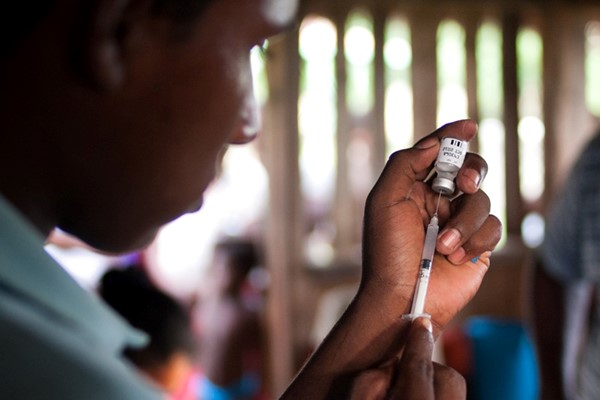 A researcher using a syringe