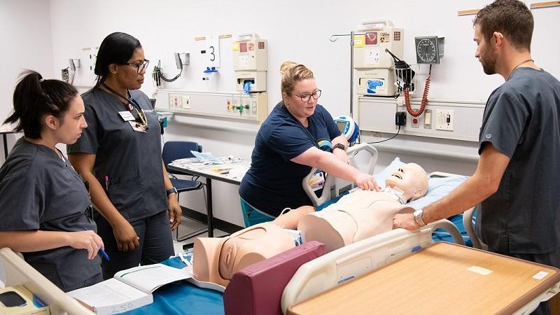 Nursing students learn with a practice dummy