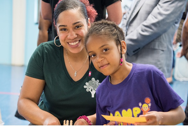 A Promise Heights worker with a child