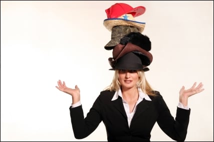 one single person balancing many hats on head only