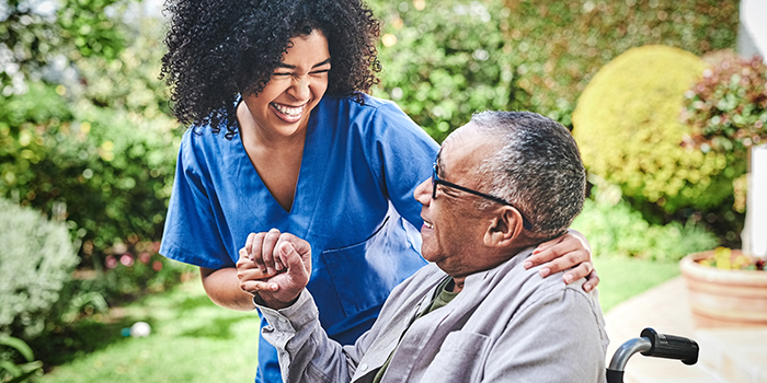 Nurse assisting senior patient in wheelchair