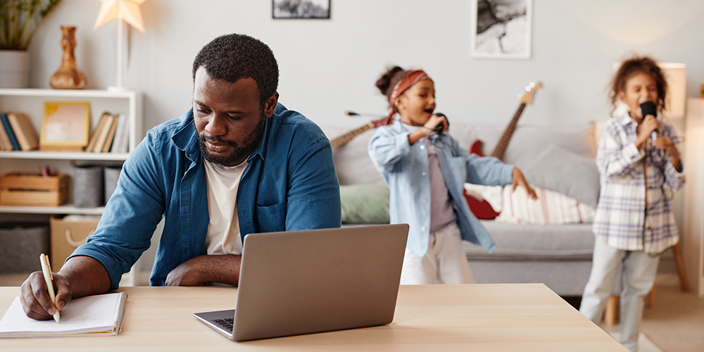 A parent works on his laptop