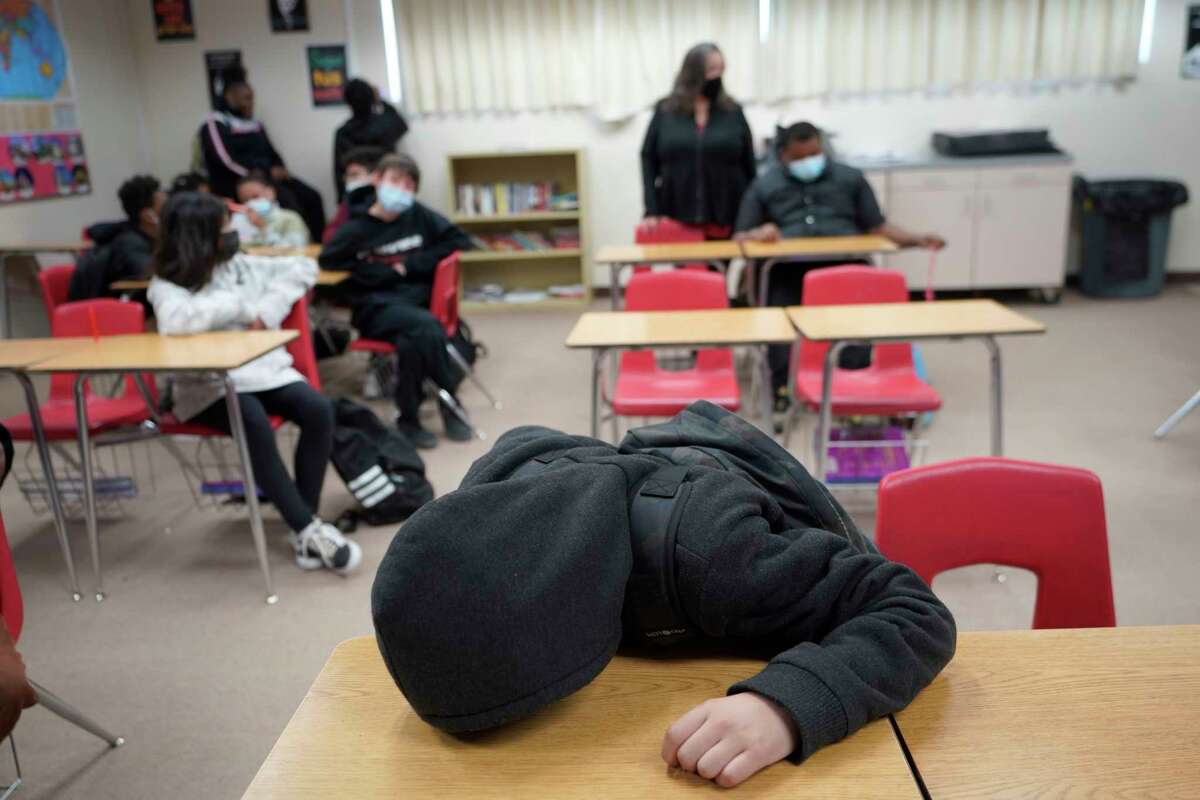 A student rests on his desk