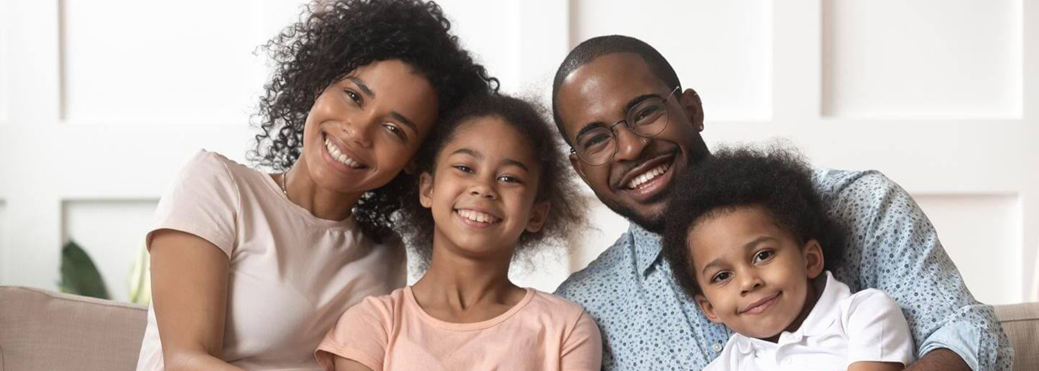 Smiling parents with their two young children