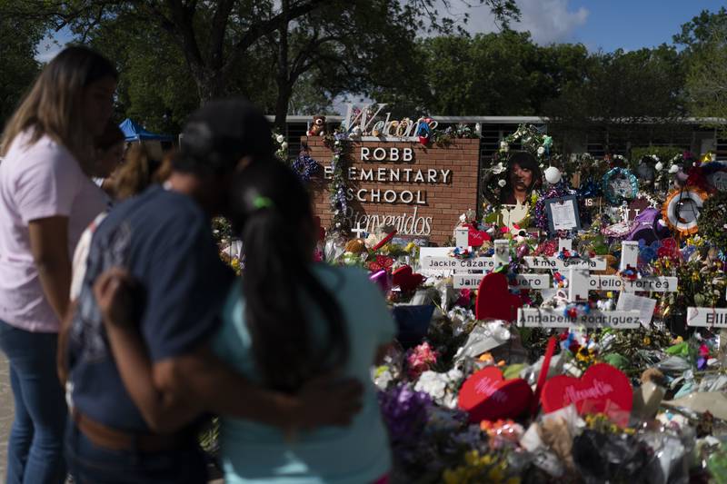 People visit a memorial at Robb Elementary School in Uvalde, Texas, on June 2, 2022, to pay their respects to the victims killed in last week's school shooting.