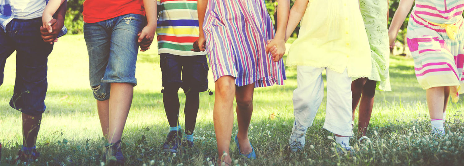 A row of children holding one another's hands