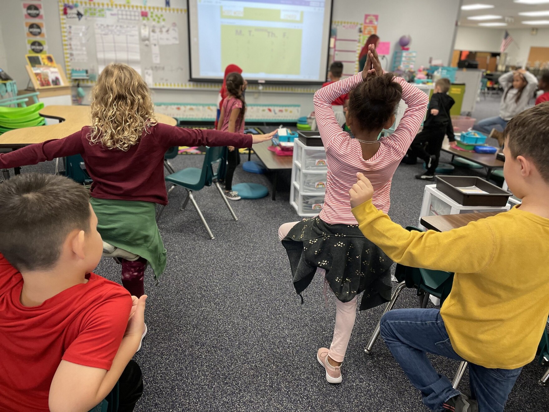 Young students exercise in a classroom