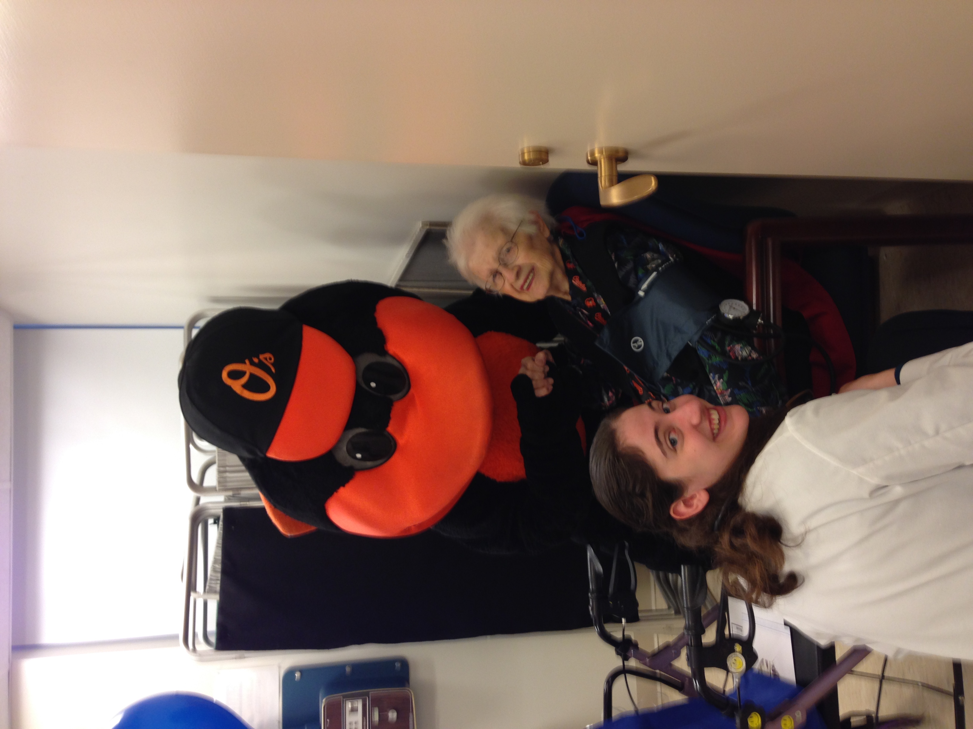 Gero student, older patient, and The Oriole Bird smiling