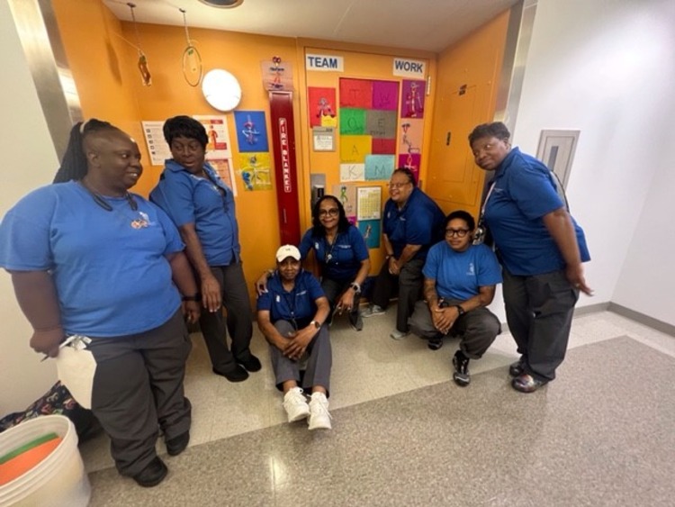 members of EVS staff posing around decorated door