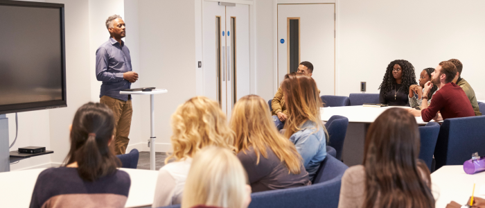 face-to-face classroom with teacher standing in front of students sitting