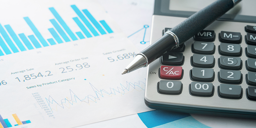 Calculator and pen on financial documents