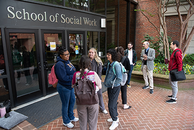 Students around the front of the building