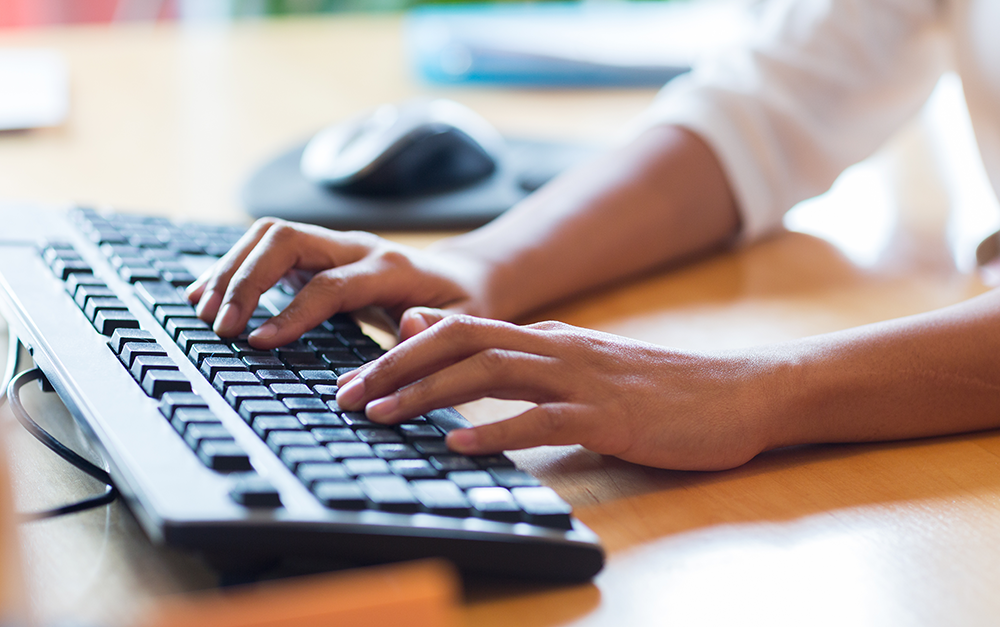 A woman typed on a keyboard