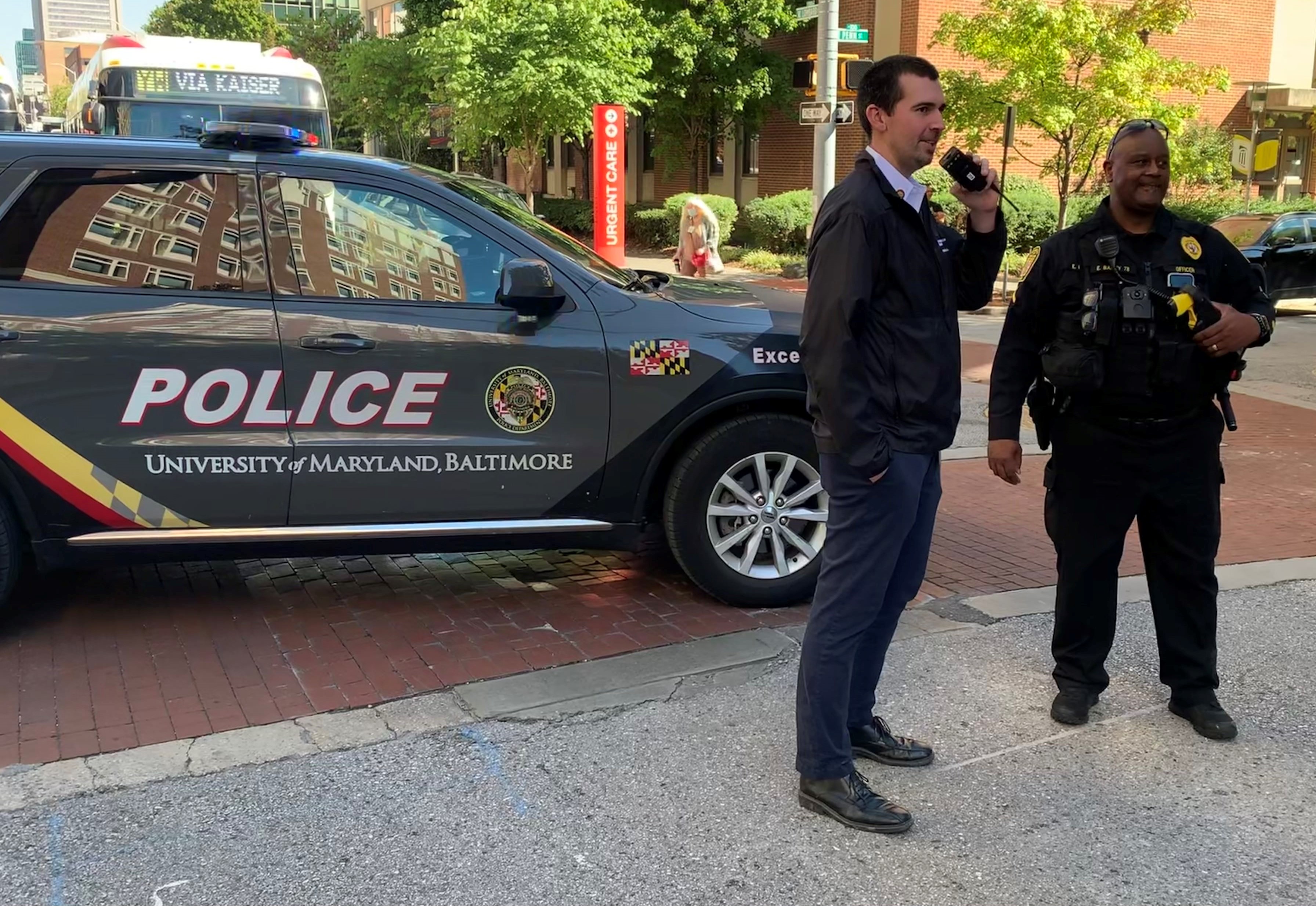 Fire Marshal & Police Officer standing next to police car