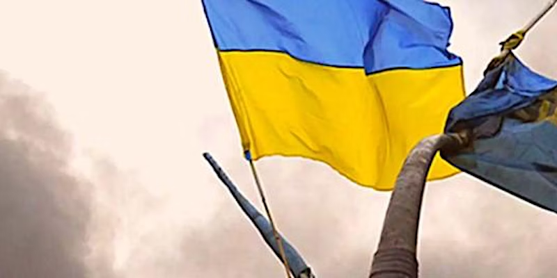 Ukraine flag flying against a cloudy sky