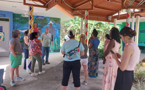 A group gathers under cover outside in Costa Rica