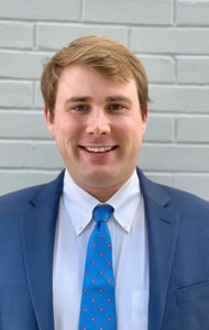 Headshot of a man in a suit