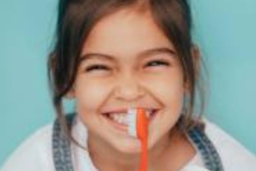 Smiling girl holding a toothbrush