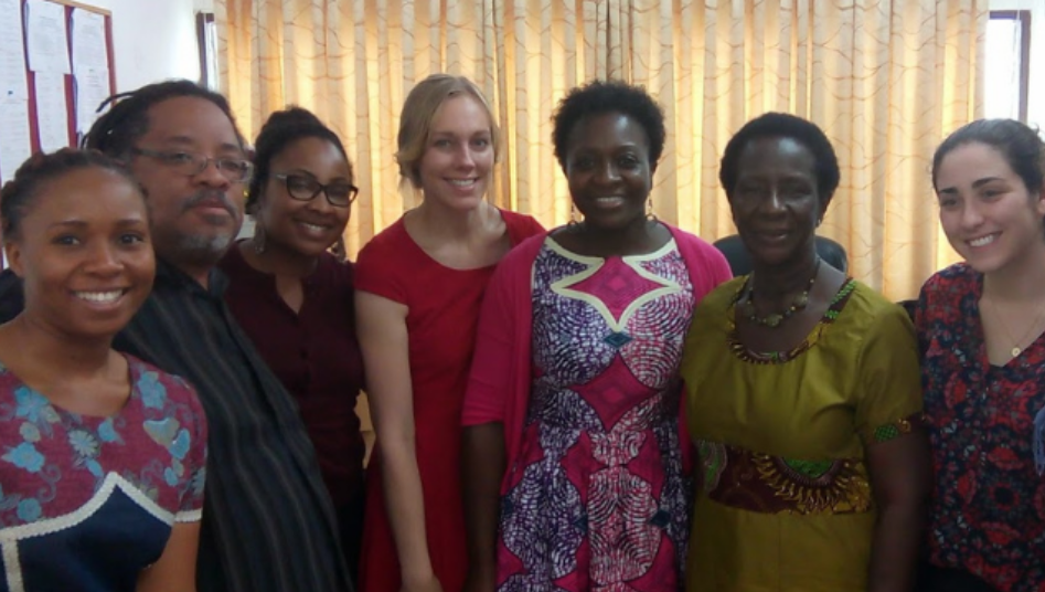 A group of people pose for a photo indoors