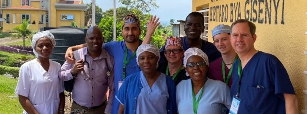 A group poses for a photo outside in Rwanda