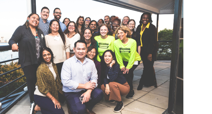 A large group of people pose for a group photo.