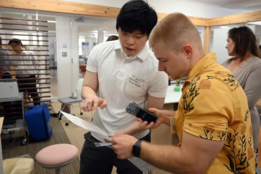 A Japanese and UMB student examine medical equipment