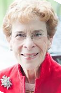 Headshot of a woman in a red jacket