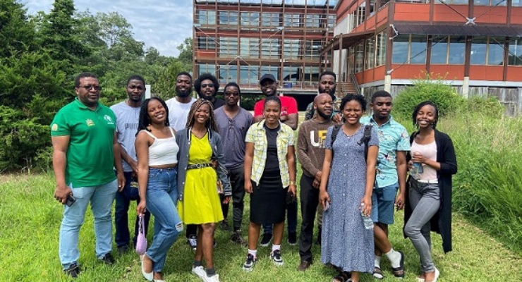 Malawi students and faculty pose for a photo outside a building