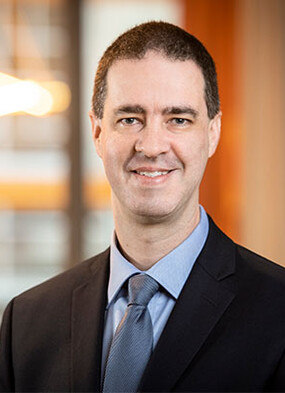 Headshot of a man in a suit