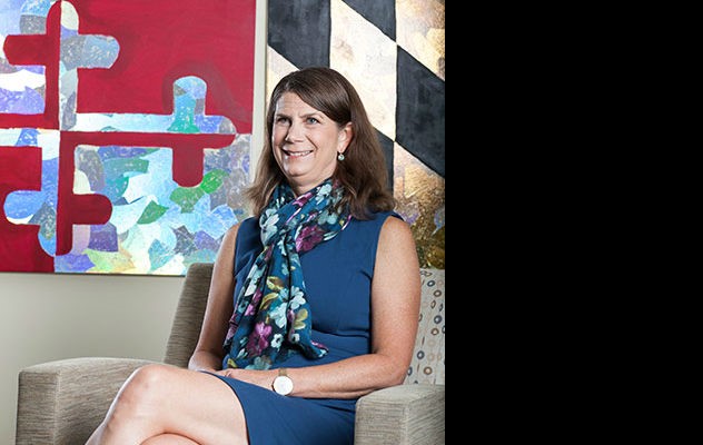 Woman sitting in front of Maryland flag background