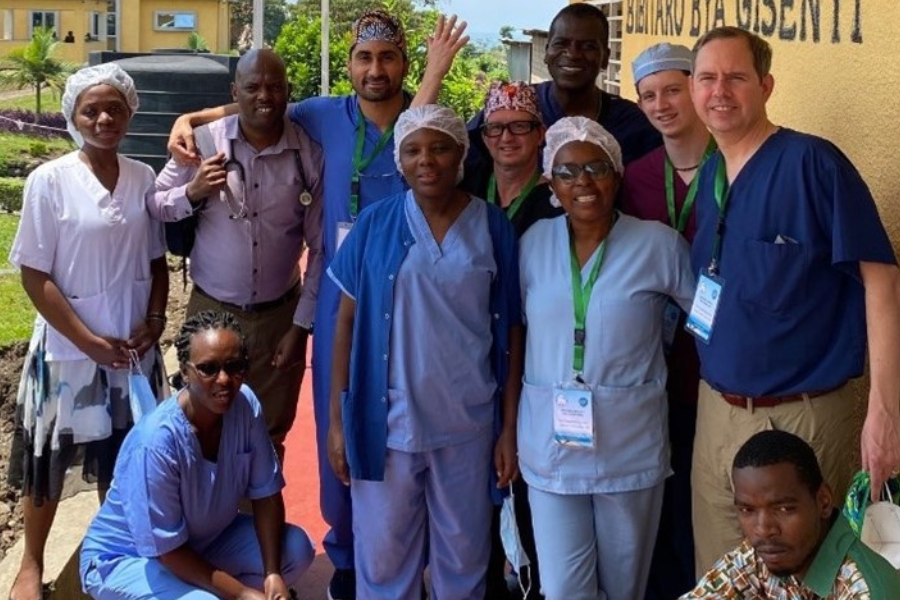 A group poses for a photo outside in Rwanda