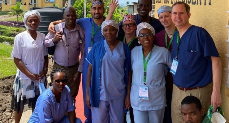 A group of people pose for a photo outside in Rwanda