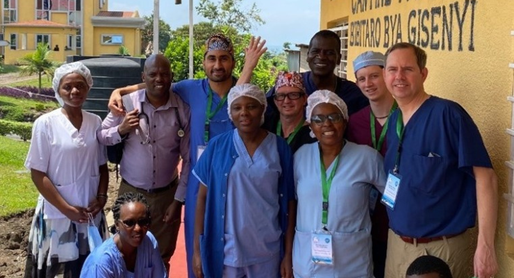 A group poses for a photo outside in Rwanda