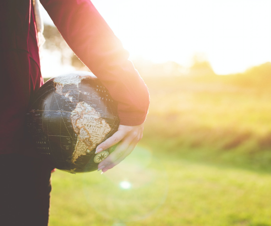 A person holding a globe