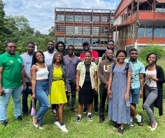 A group of students pose for a photo outside