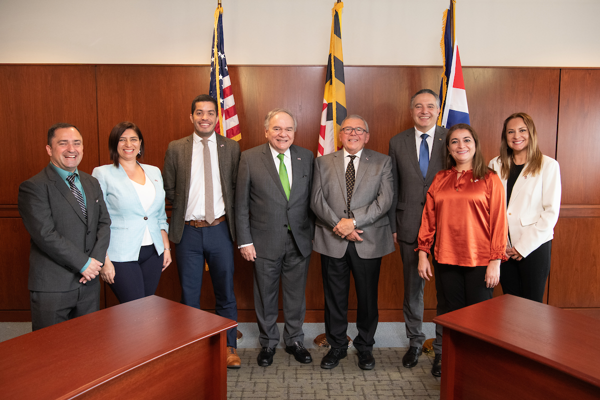 Men and woman from Costa Rica pose for a photo in the President's Board Room