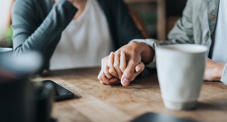 Two people holding hands