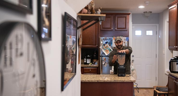 LNYW participant Justin Hanna prepares a smoothie in his renovated kitchen.