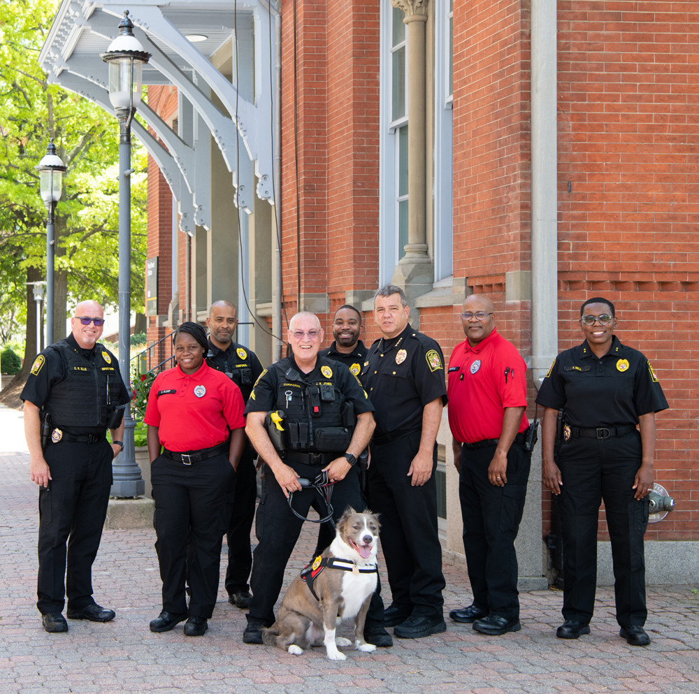 (l-r) Acting Deputy Chief Chad Ellis, Security Officer Kierra Alsup, Cpl. Yale Partlow, Cpl. JR Jones, Comfort K9 Lexi, Lt. Matthew Johnson, Interim Chief Thomas Leone, Security Supervisor William Griffin, Acting Deputy Chief Tonya Bell