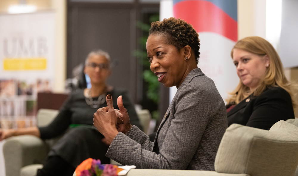 Host Renée McDonald Hutchins and Carolyn Ringer Lepre listen as Valerie Sheares Ashby addresses the audience.