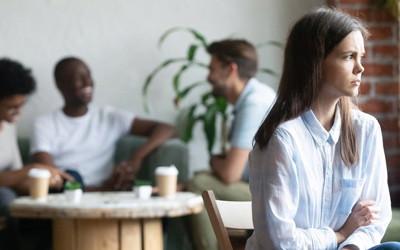 Woman with scizophrenia faces away from group