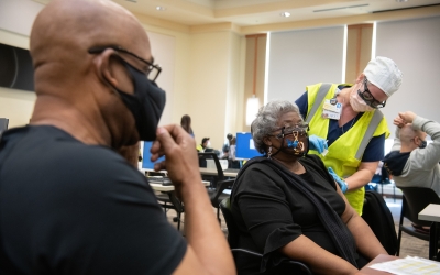 Bishop Walter Scott Thomas and his wife, Patricia, receive their first doses of the COVID-19 vaccine at the SMC by nurse Sandra Selby. Bishop Thomas is the pastor at New Psalmist Baptist Church. Matthew P. D'Agastino/University of Maryland, Baltimore