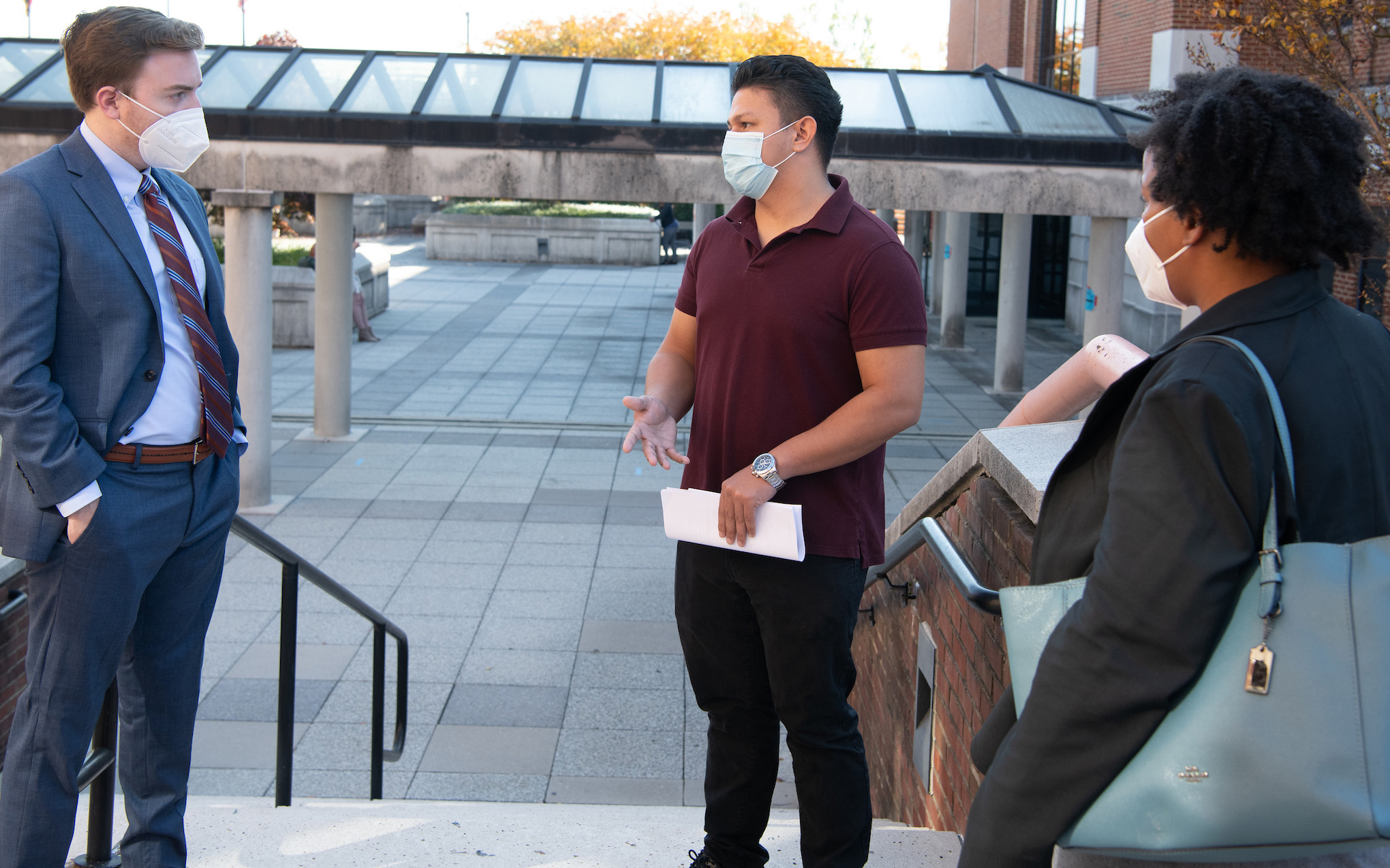 Erick Pacas Guerra (center) received guidance and representation from UMB's Eviction Prevention Program. Law students Jamy Klotzbach (left) and Nia Lesesne (right) went to an in-person hearing at the Hyattsville District Court. 