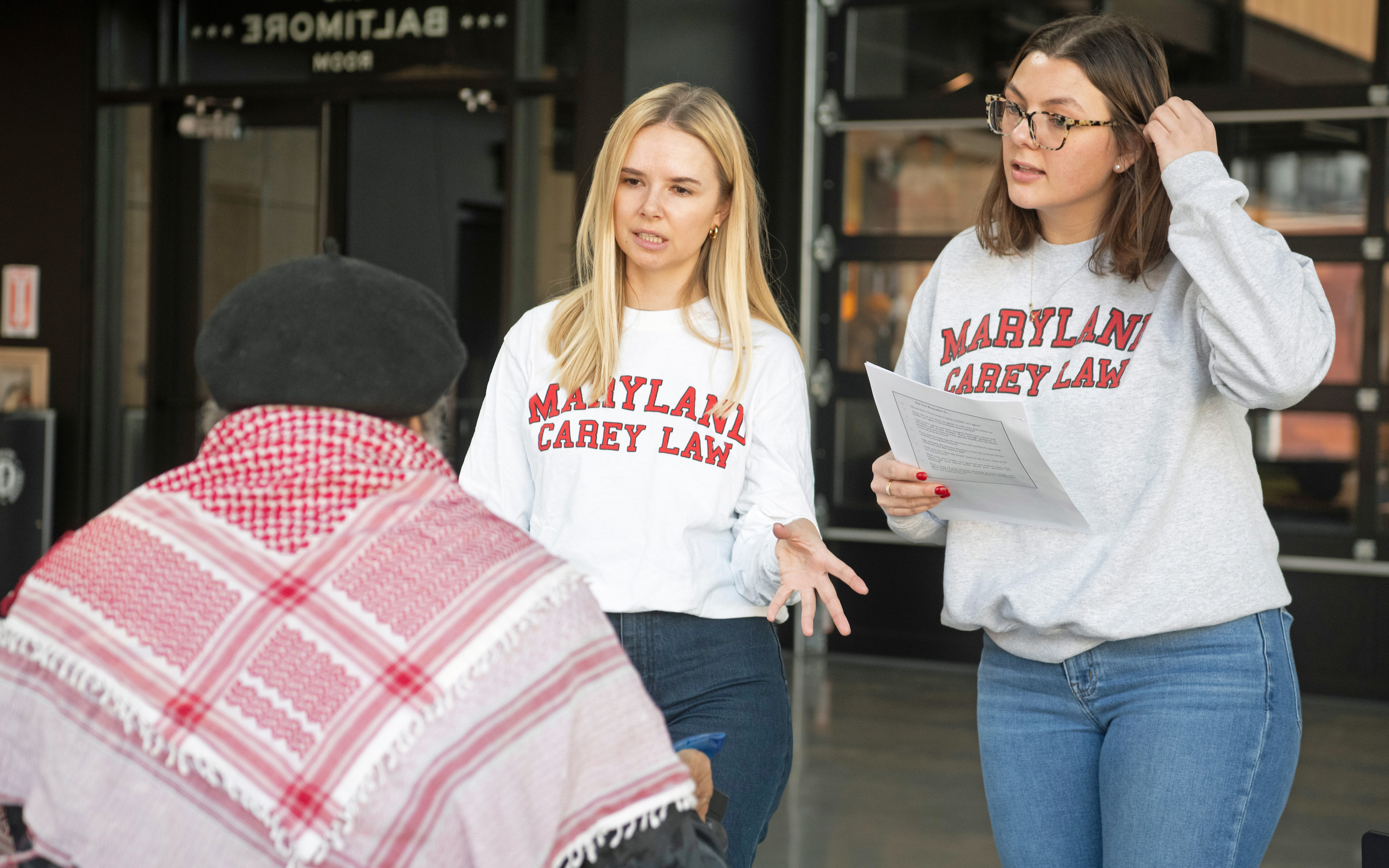 Law students speaking to a man at Lexington Market