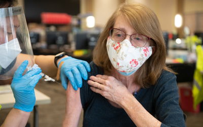 First week of the UMB-led vaccine clinic in the SMC. Nancy Stiegler, from Baltimore City, receives her Moderna vaccine.