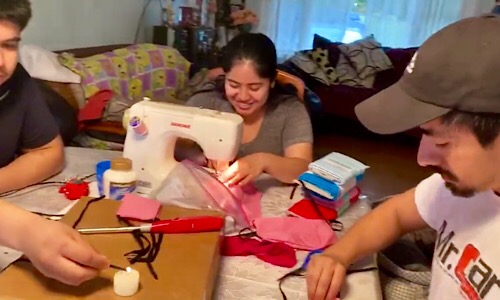 University of Maryland School of Nursing student Maria Segovia fires up her sewing machine to make cloth face masks as part of the school's mask donation drive.  