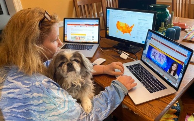 University of Maryland School of Medicine Director of Marketing and Public Relations Joanne Morrison teleworks at home with her dog, Ben.