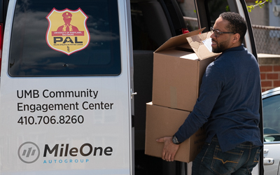 Borndavid McCraw, PAL Program coordinator at the UMB Community Engagement Center (CEC), packs the PAL van with donated care packages to be delivered to the families involved in the UMB PAL Program.