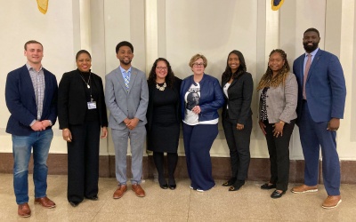 From left, Brendon Frankel, Kimberly Lagree, Mayor Brandon Scott, Margo Candelaria, Kimberly Haven, Deputy Mayor Faith Leach, Tracy Estep, and Wesley Dawson.